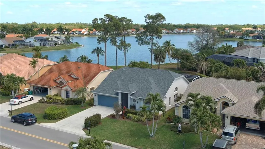Aerial perspective of suburban area with a large body of water