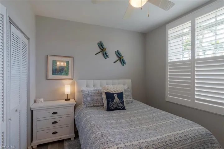 Bedroom with a ceiling fan and a closet