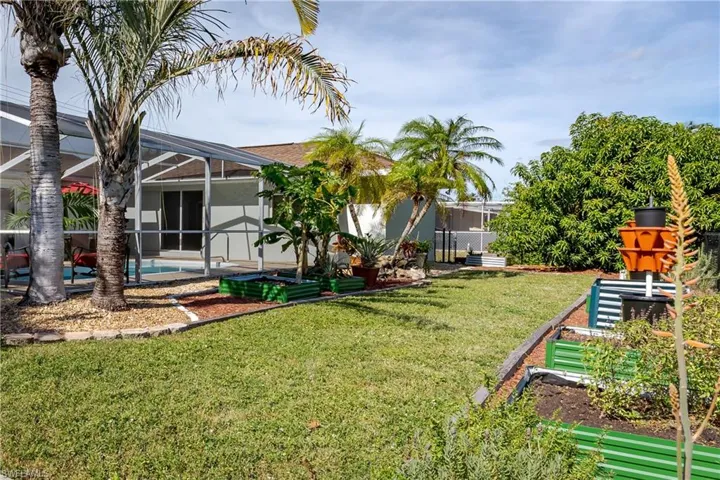 View of yard with a lanai and and swimming pool