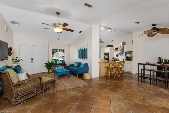 Living room with track lighting and vaulted ceiling