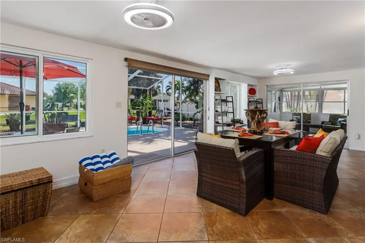 Tiled dining room with a healthy amount of sunlight
