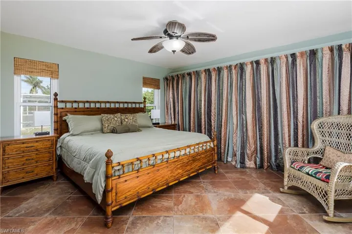 Bedroom featuring multiple windows and ceiling fan