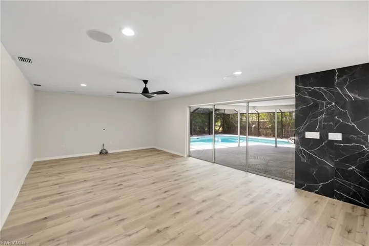 Unfurnished living room with wood finished floors, ceiling fan, and recessed lighting