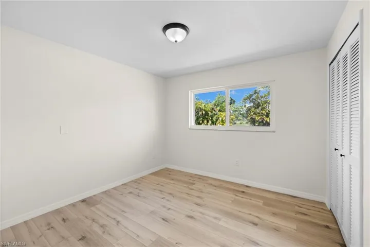 Unfurnished bedroom with light wood-style floors and a closet
