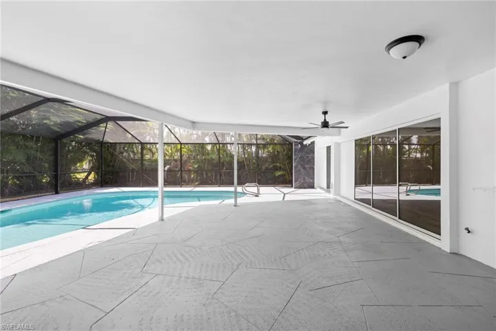Swimming pool with a patio and a lanai