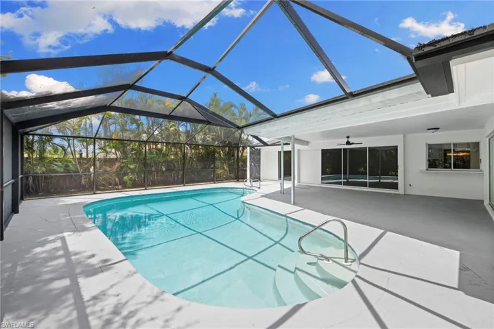 Swimming pool featuring ceiling fan and a patio