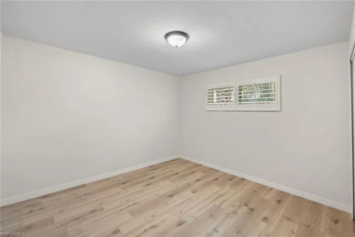 Spare room featuring light wood finished floors and baseboards