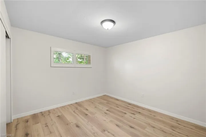 Unfurnished bedroom featuring a closet and light wood-style floors