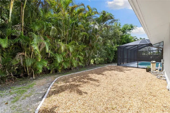 View of yard featuring an outdoor pool and glass enclosure
