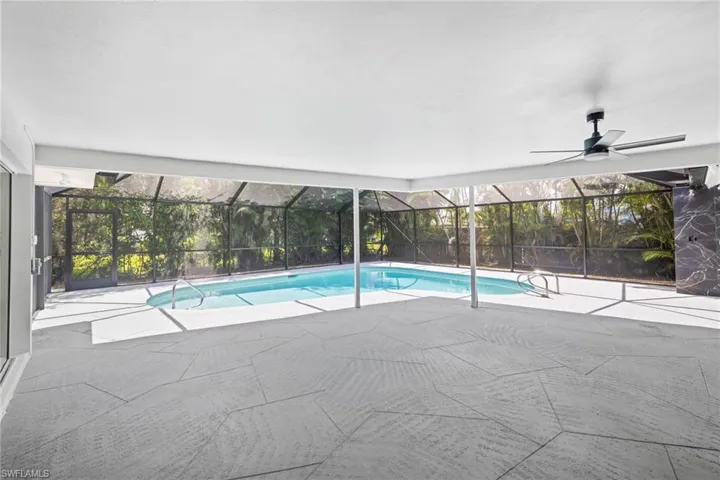 Swimming pool featuring a patio and a lanai