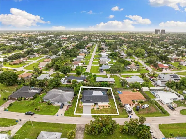 Aerial view of residential area featuring property boundaries highlighted