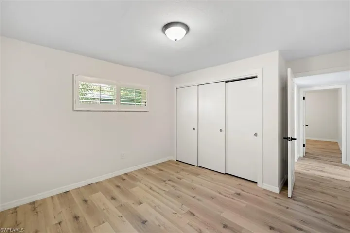 Unfurnished bedroom with light wood finished floors and a closet