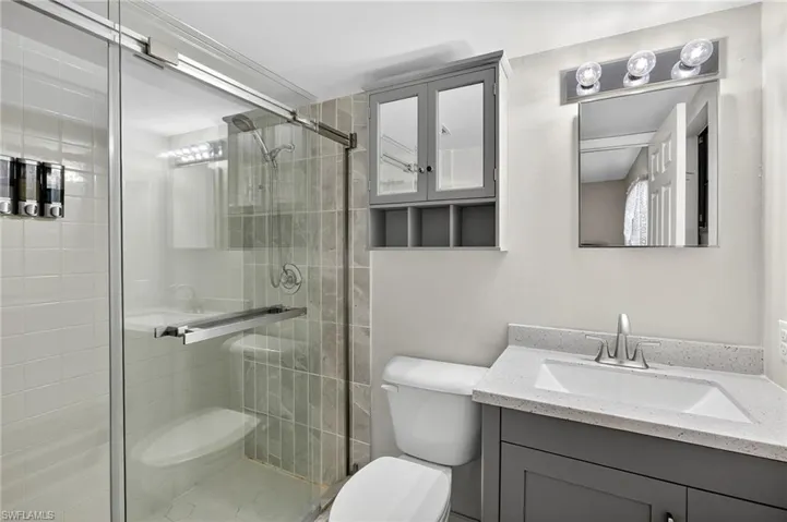Bathroom featuring a stall shower and vanity