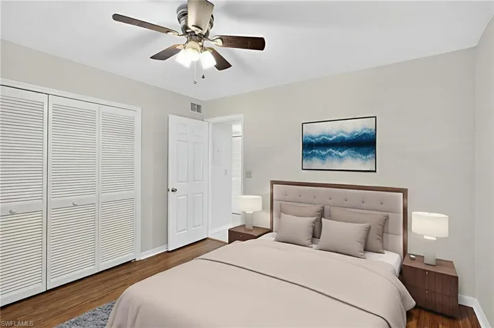 Bedroom featuring dark wood finished floors, a closet, and a ceiling fan
