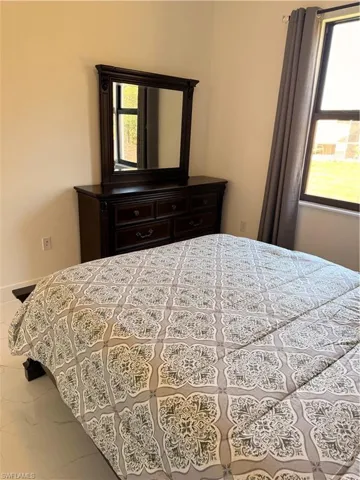 Bedroom with marble look tile flooring