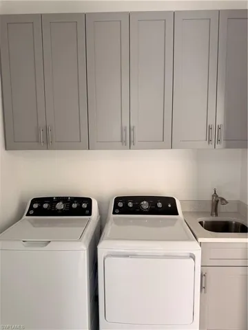 Laundry area with cabinet space and separate washer and dryer