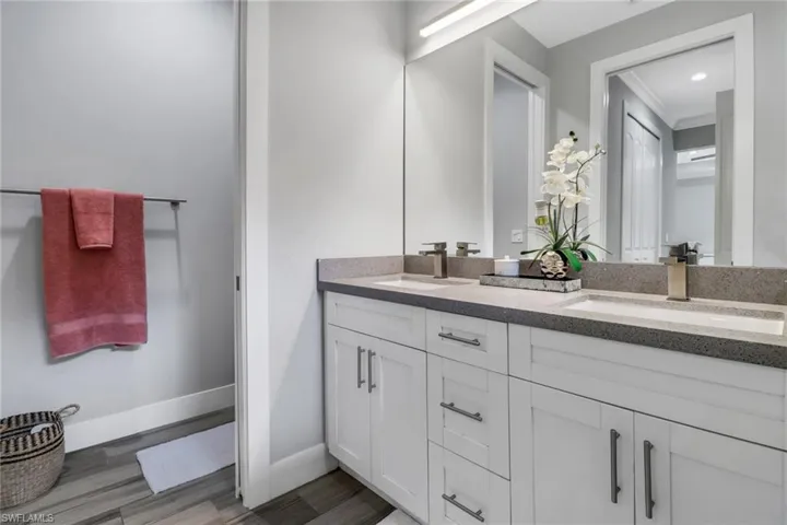 Bathroom featuring dual vanity and ornamental molding