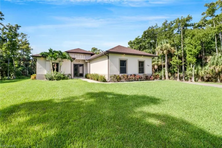 Mediterranean / spanish house featuring a front lawn