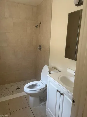 Full bathroom featuring vanity, a shower stall, and light tile patterned floors