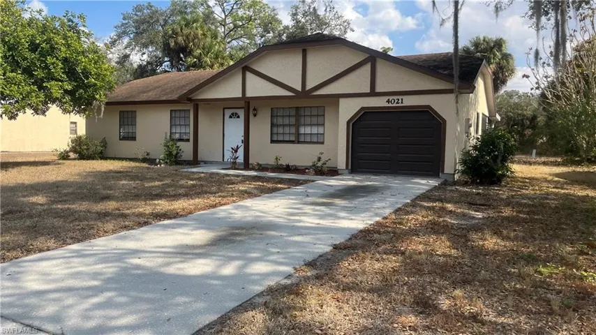 View of front of house featuring an attached garage, driveway, stucco siding, and a shingled roof