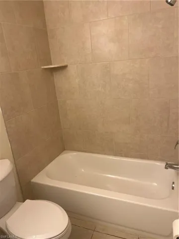 Bathroom featuring tile patterned flooring and shower / washtub combination