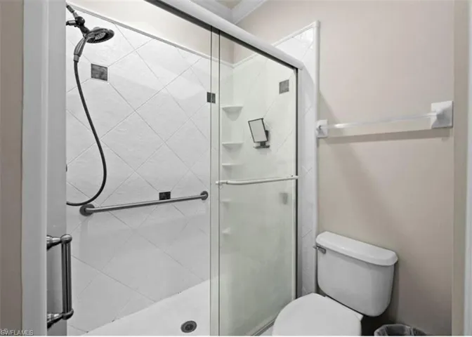 Bathroom with a shower with shower door and toilet