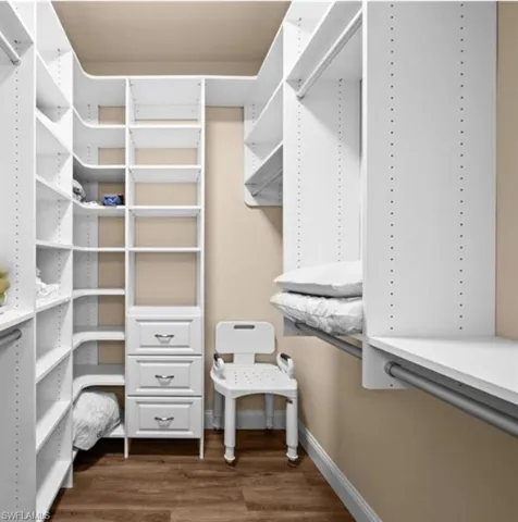 Walk in closet featuring hardwood / wood-style floors