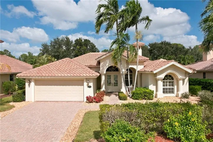 Welcoming Front Exterior with Tropical Landscaping