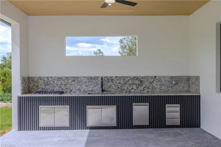 View of patio featuring a ceiling fan and a sink