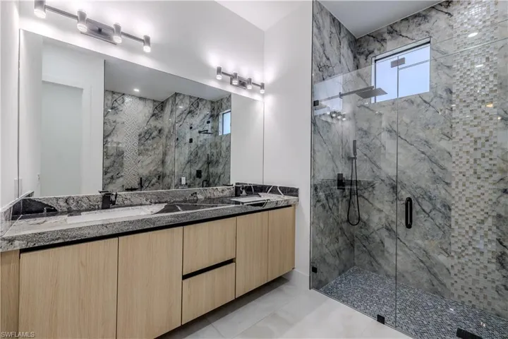 Washroom with a sink and light tile patterned flooring