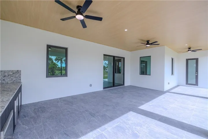 Detailed view of ceiling fan and stucco siding