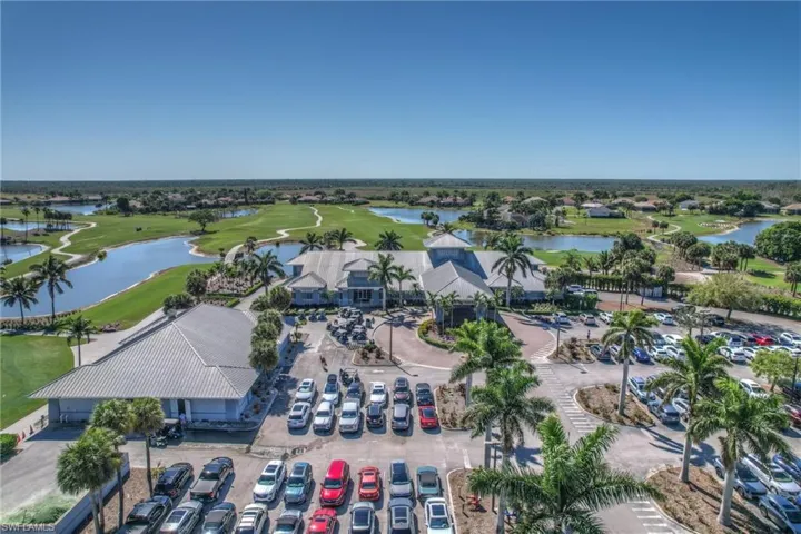 Birds eye view of property with view of golf course and a water view