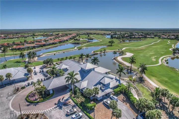 Drone / aerial view featuring view of golf course, a water view, and a residential view