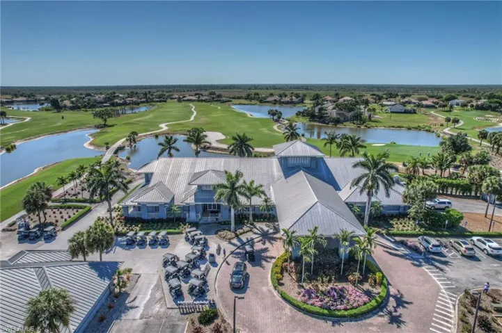 Aerial view featuring a water view and golf course view