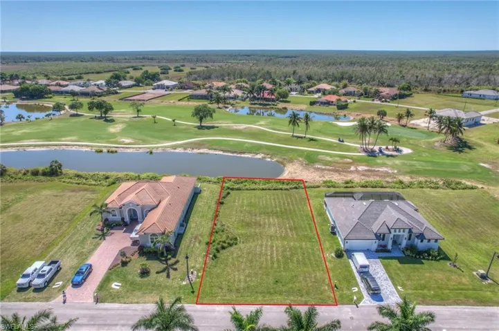 Birds eye view of property with golf course view and a water view