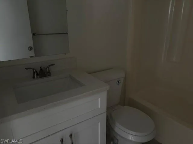 Full bath featuring vanity and washtub / shower combination