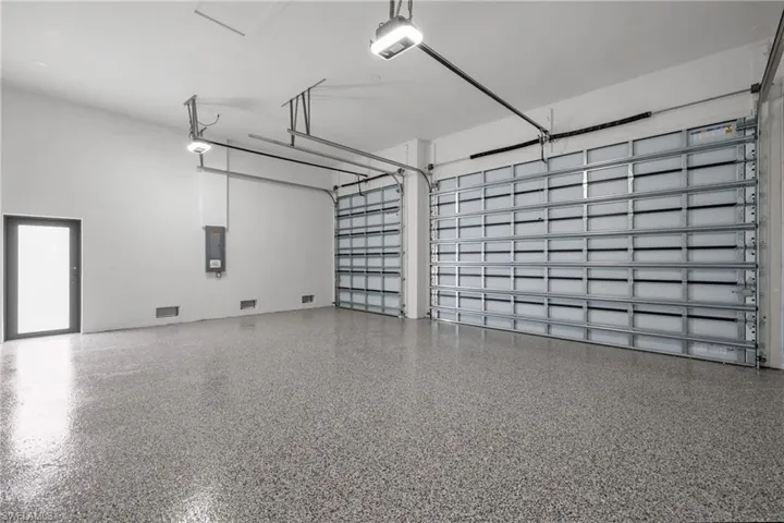 Garage with a garage door opener and electric panel