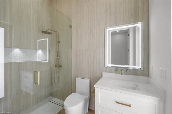 Bathroom with a shower stall and vanity