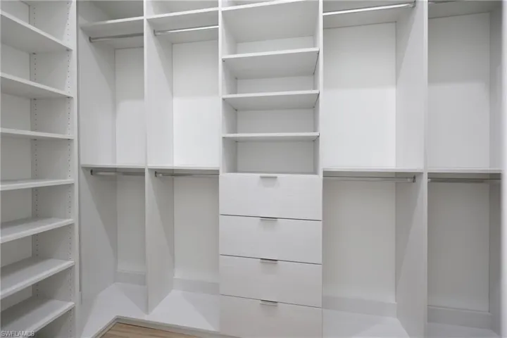 Spacious closet with light wood-type flooring