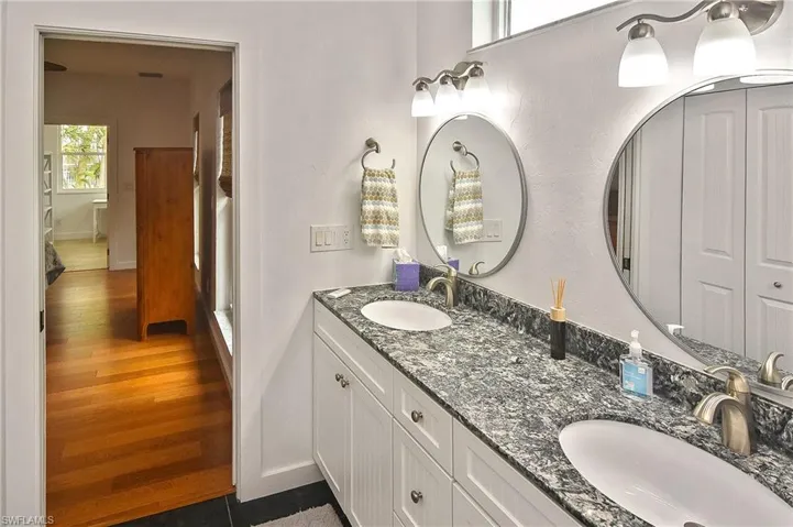 Bathroom featuring a healthy amount of sunlight, tile patterned flooring, and vanity