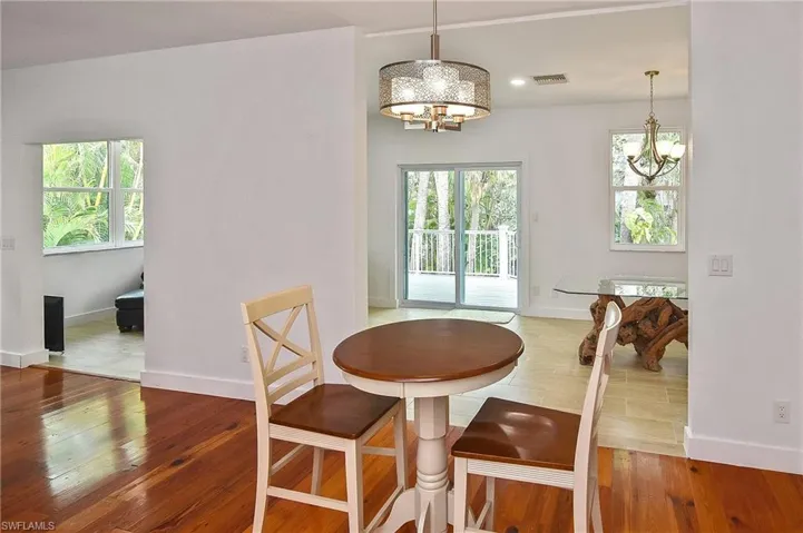 Dining space with a chandelier and wood-type flooring