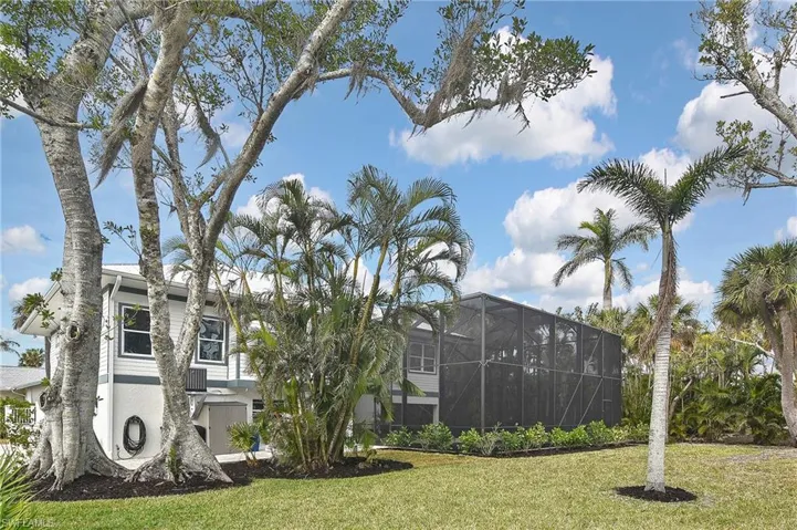 View of home's community with a lawn