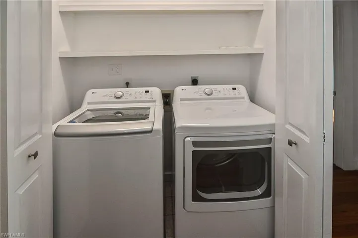 Laundry room with washer and clothes dryer