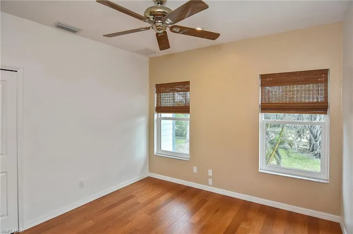 Spare room featuring ceiling fan and hardwood / wood-style flooring
