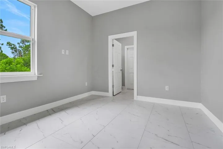 Empty room with baseboards and light marble finish flooring