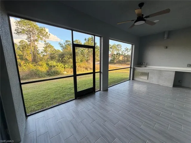 Unfurnished sunroom with ceiling fan