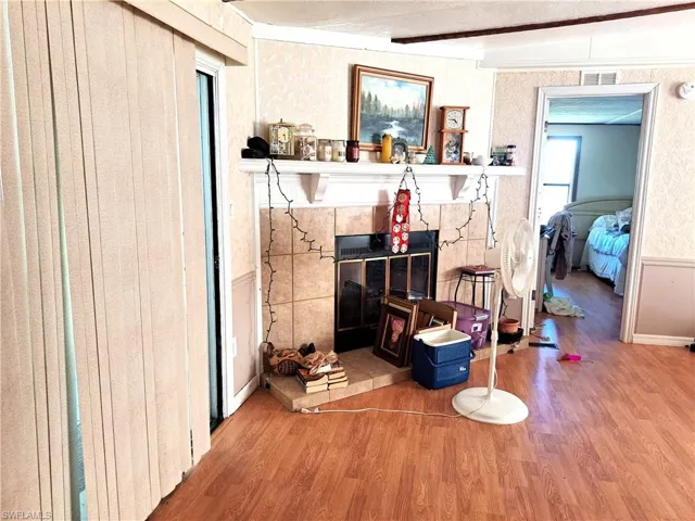 Main living room with hardwood / wood-style flooring and fireplace