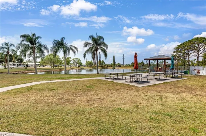 View of community with a gazebo, a water view, and a lawn