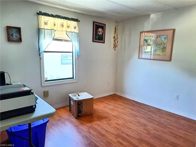 Office area with hardwood / wood-style flooring