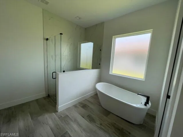 Master bathroom with soaking tub and separate shower